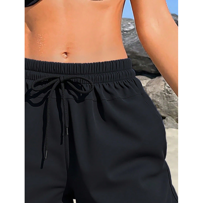 Women's sporty swim shorts with elastic waistband and practical pockets Mune Fashion