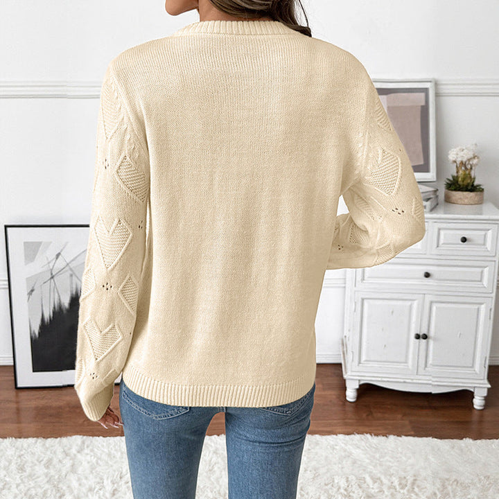 Women's fine knit sweater with openwork heart pattern, applied decorative heart and round neckline