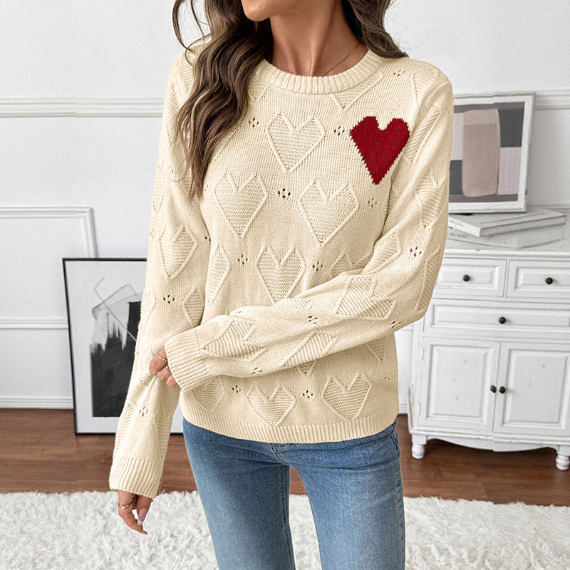 Women's fine knit sweater with openwork heart pattern, applied decorative heart and round neckline